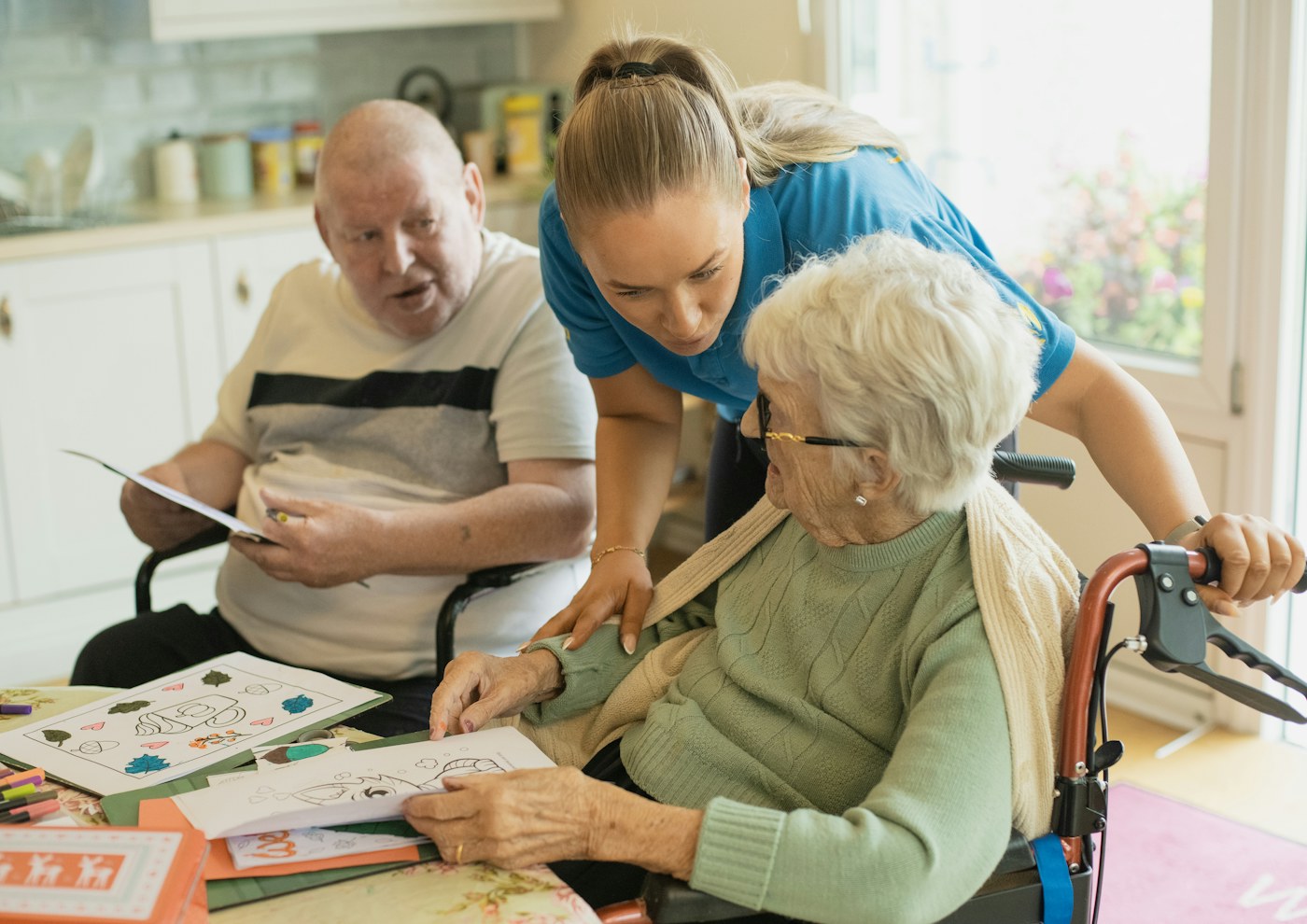 Care worker and residents taking part in an activity